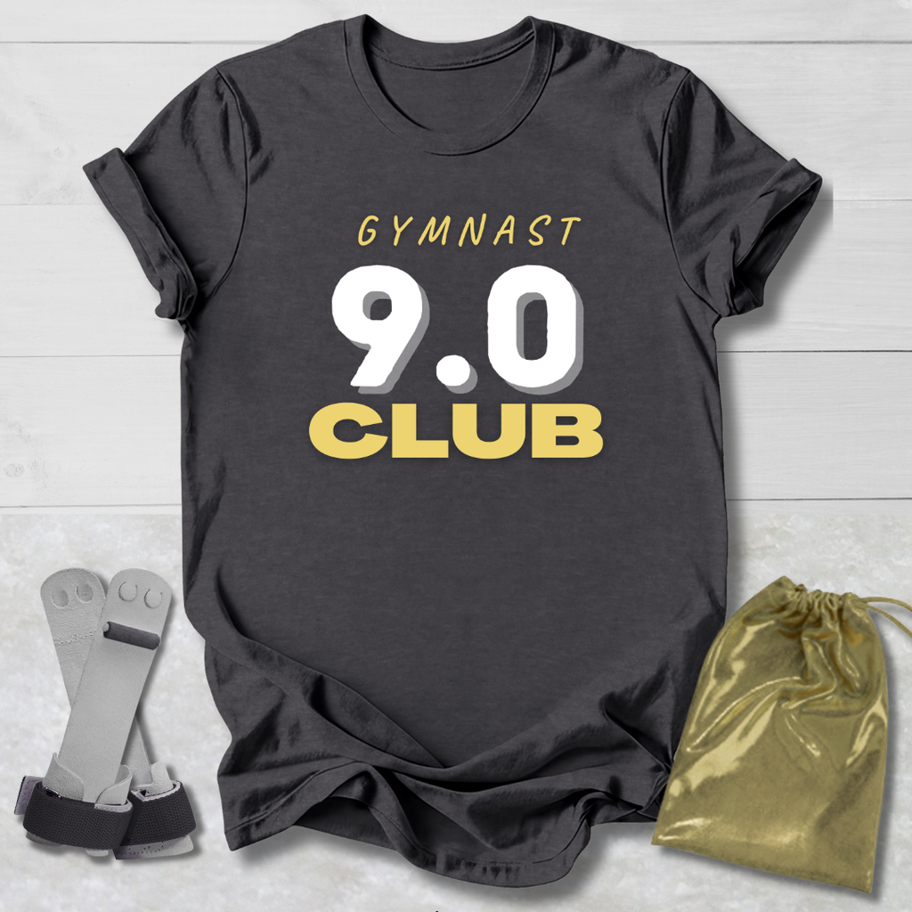 Maroon t-shirt with 'It's a gymnast thing (you wouldn't understand)' text, socks, and drawstring bag on a light wooden surface.