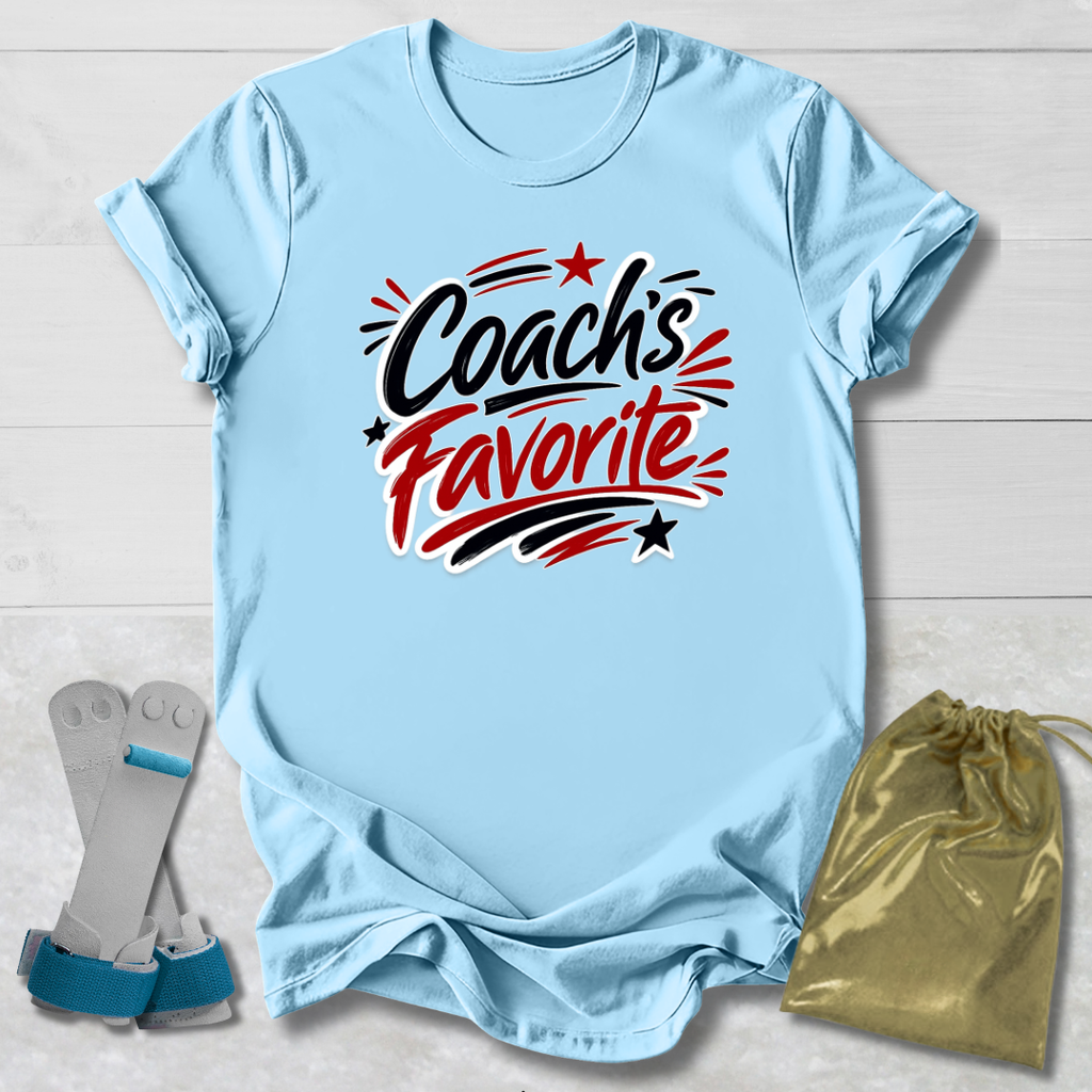 Light blue t-shirt with 'Coach's Favorite' text on a light wooden surface with socks and a drawstring bag.