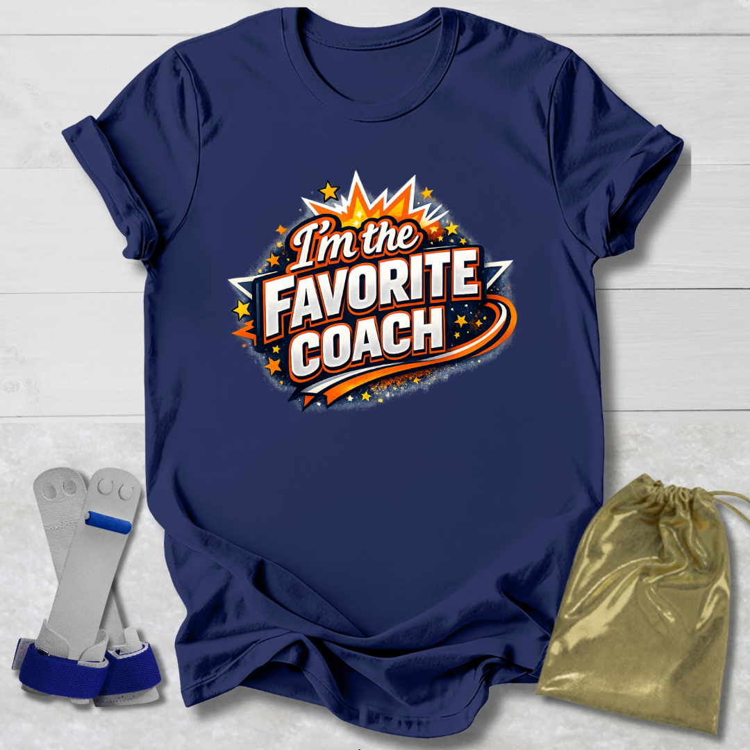 Navy blue t-shirt with 'I'm the Favorite Coach' design on a light wooden surface.