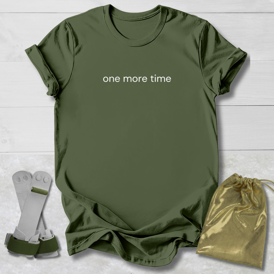 Green t-shirt with 'one more time' text, socks, and drawstring bag on a light wooden surface