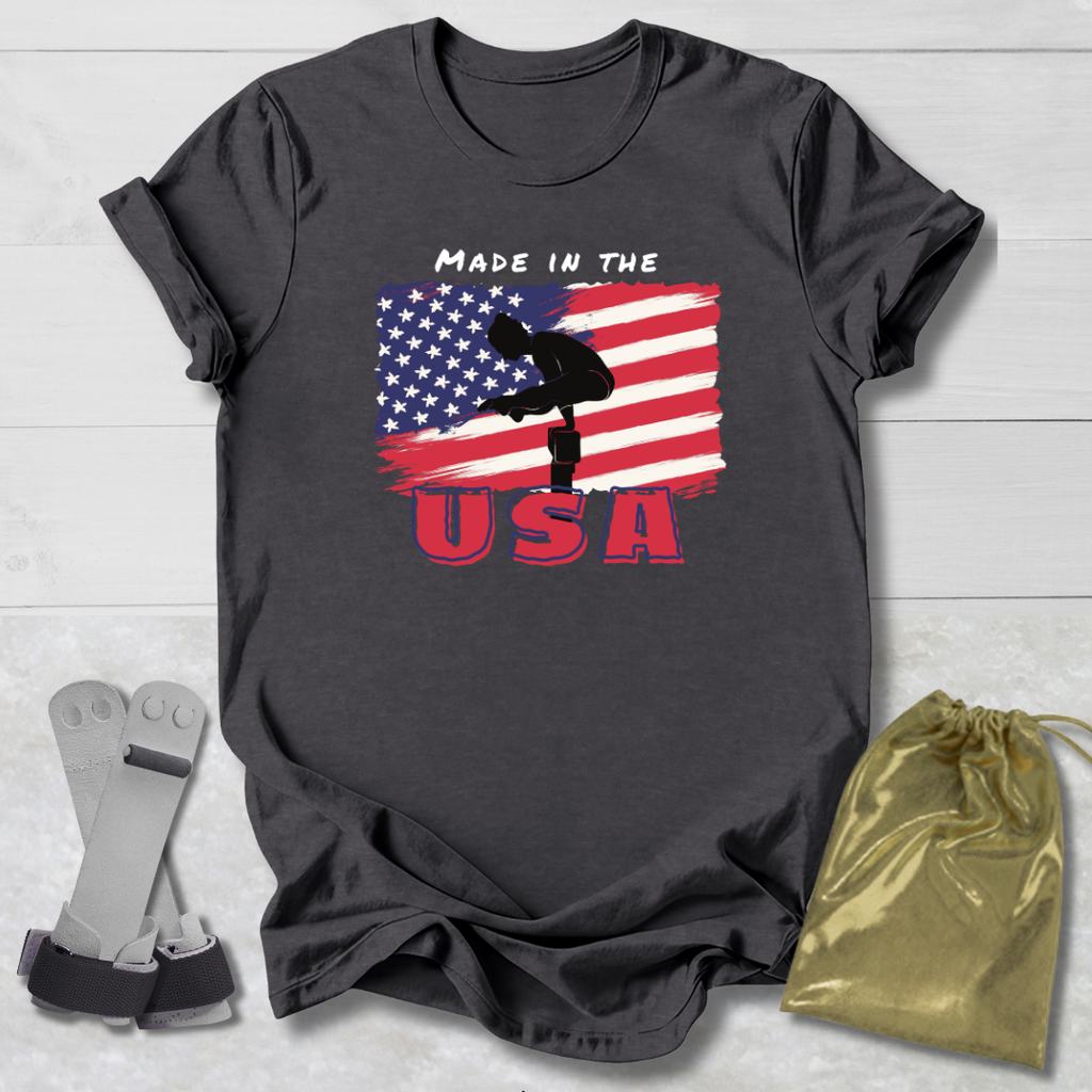 Gray t-shirt with Gymnast American flag graphic and 'Made in the USA' text on a wooden surface.