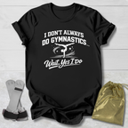 Black t-shirt with a humorous gymnastics graphic and I don't always do gymnastics . . . wait, yes I do text on a light wooden surface.