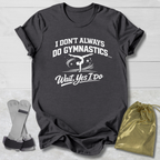 Gray t-shirt with a humorous gymnastics graphic and I don't always do gymnastics . . . wait, yes I do text on a light wooden surface.