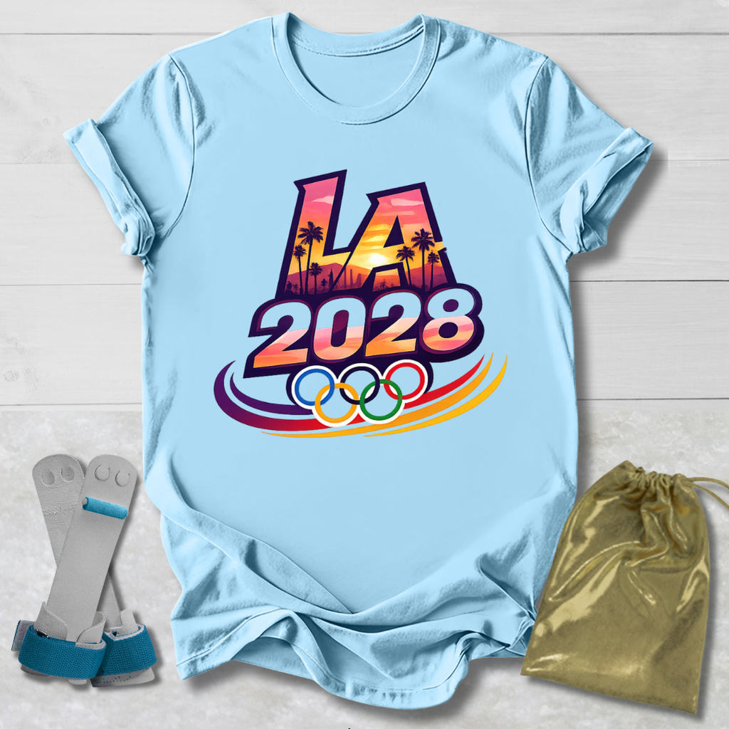 Light blue t-shirt with 'LA 2028' design, socks, and drawstring bag on a wooden surface