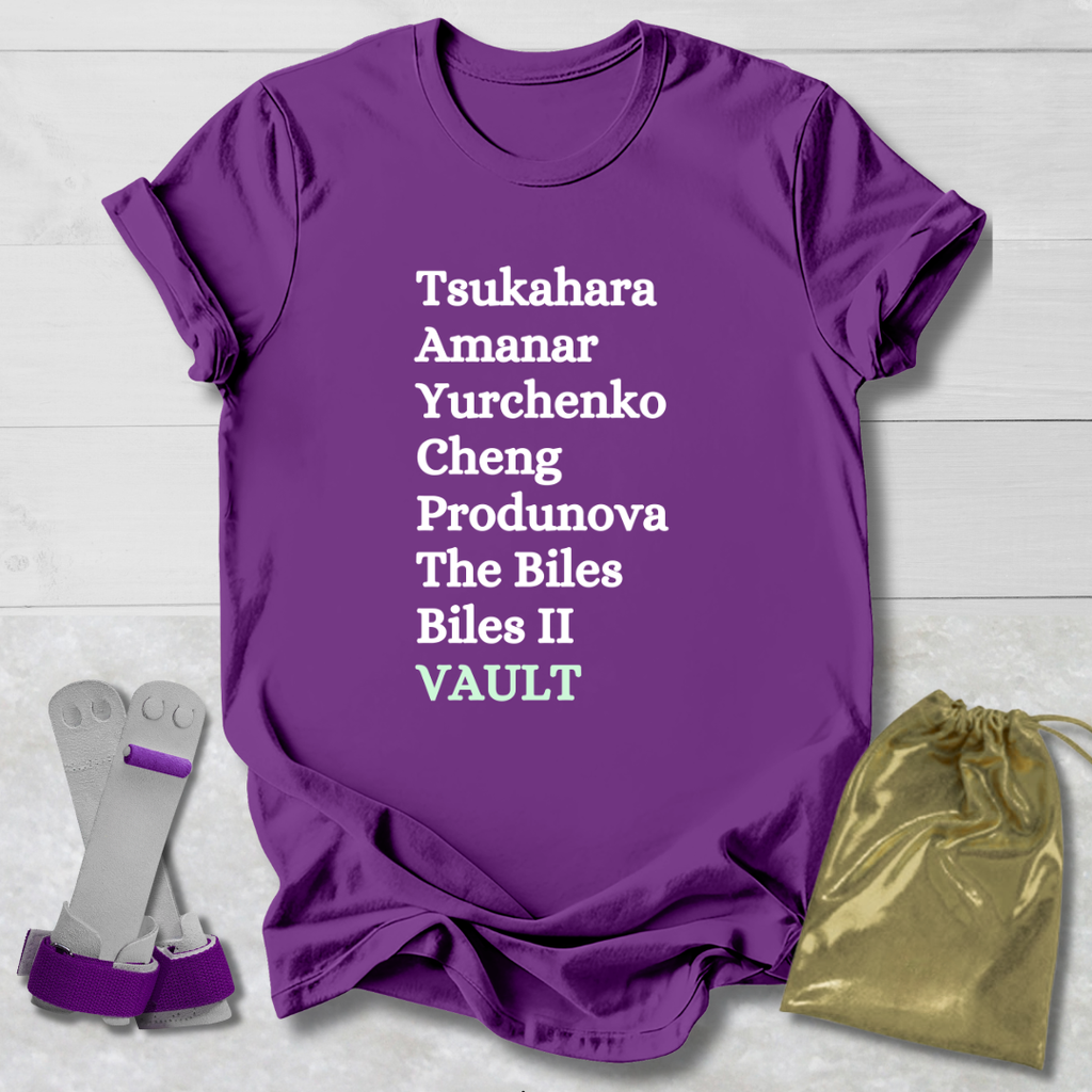 Purple t-shirt with gymnast vault skills text, socks, and drawstring bag on a light wooden surface