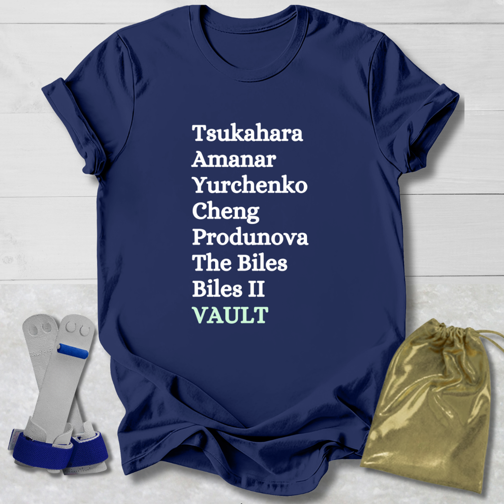 Navy blue t-shirt with  gymnast vault skills white text on a light wooden surface with socks and a drawstring bag.