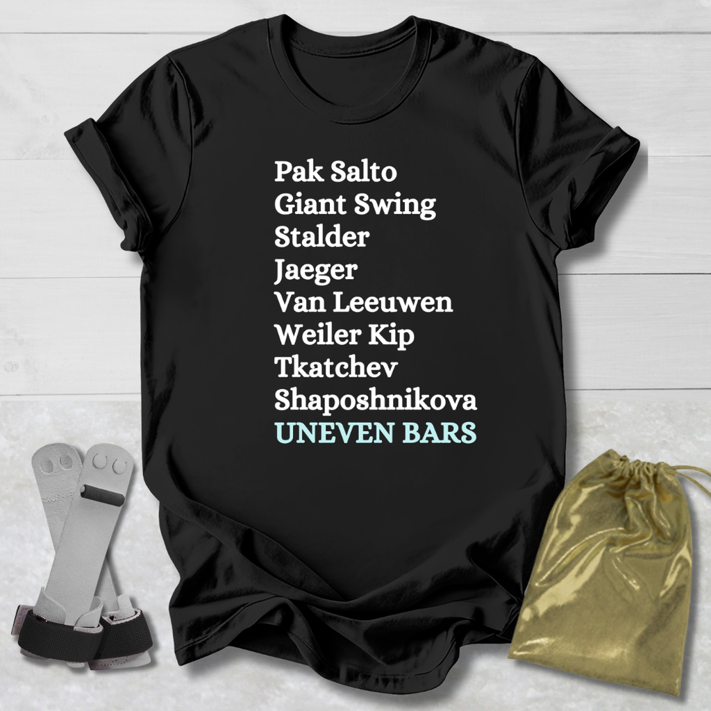 Black t-shirt with white gymnast uneven bars skills text on a wooden surface with socks and a drawstring bag.