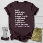 Brown t-shirt with floor exercise skills text, socks, and drawstring bag on a light wooden surface
