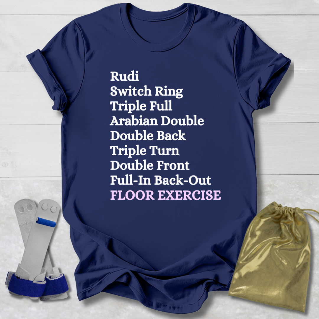 Navy blue t-shirt with white  gymnast floor exercise skills text on a light wooden surface, accompanied by socks and a drawstring bag.