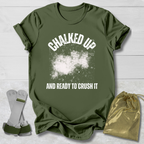 Green t-shirt with 'Chalked Up and Ready to Crush It' text, socks, and drawstring bag on a light wooden surface.