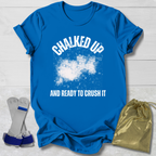 Blue t-shirt with 'Chalked Up and Ready to Crush It' text, socks, and drawstring bag on a light wooden surface.