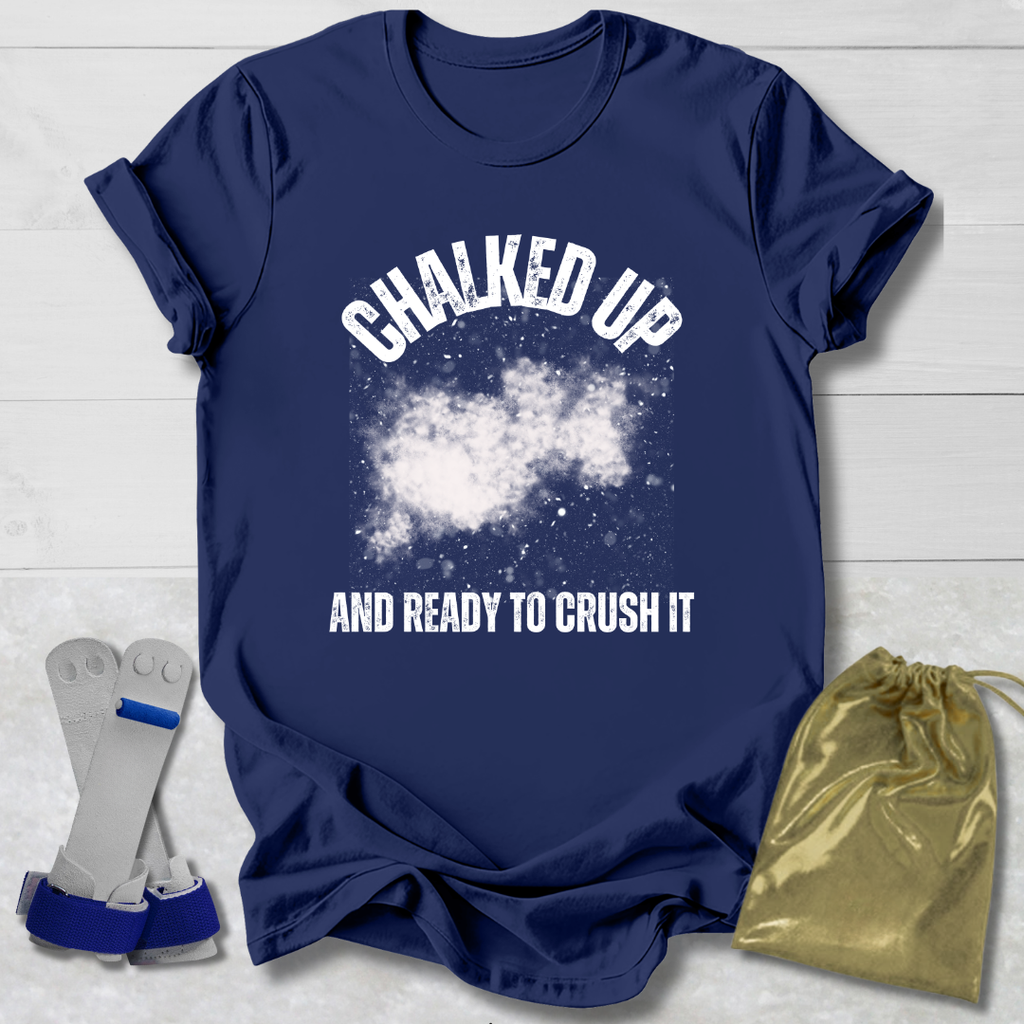 Navy blue t-shirt with 'Chalked Up and Ready to Crush It' text, socks, and drawstring bag on a light wooden surface.