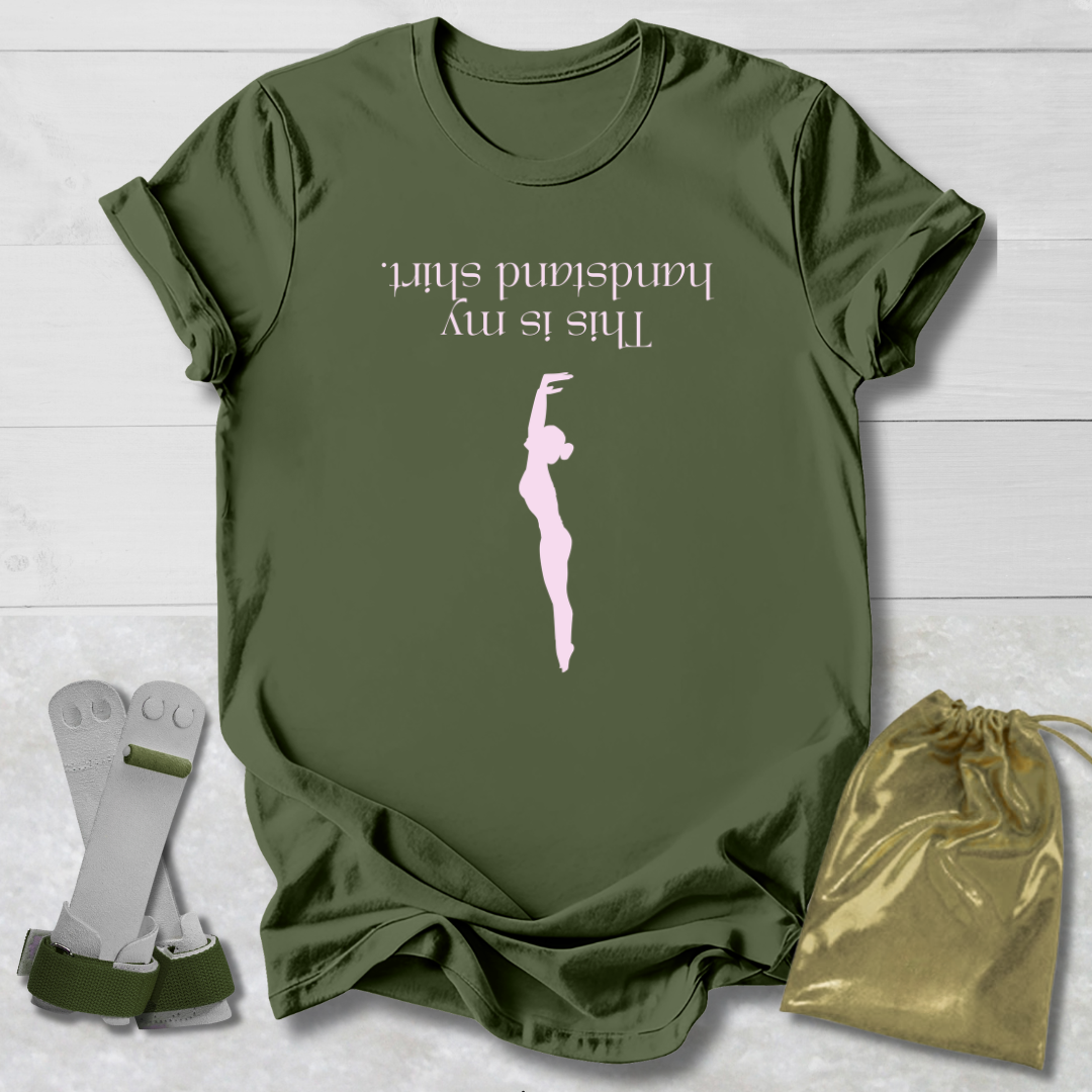 Green t-shirt with graphic and  this is my handstand shirt  text, socks, and drawstring bag on a light wooden surface