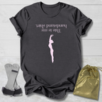 Dark gray t-shirt with a graphic and  this is my handstand shirt text, socks, and a drawstring bag on a light wooden surface.