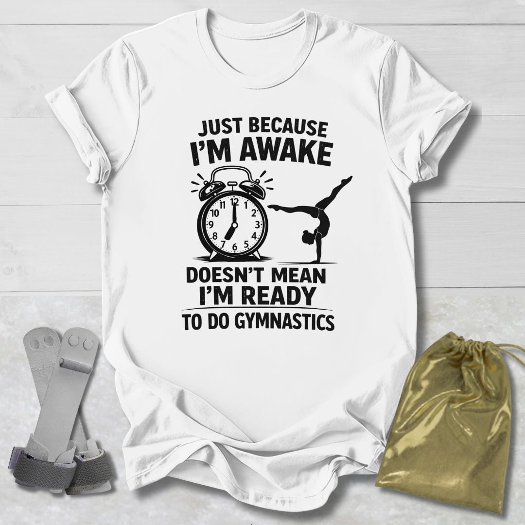 White t-shirt with black graphic and  gymnast text on a light wooden surface, with socks and a drawstring bag.