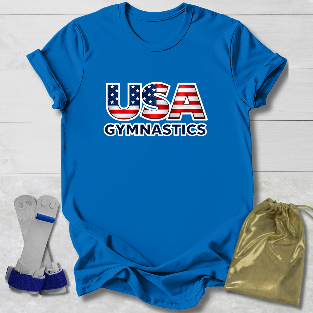 Blue t-shirt with 'USA Gymnastics' text, socks, and drawstring bag on a light wooden surface