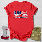 Red t-shirt with 'USA Gymnastics' design, socks, and drawstring bag on a light wooden surface