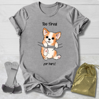 Gray t-shirt with a corgi graphic and  too tired for bars gymnast text, socks, and a drawstring bag on a light wooden surface.