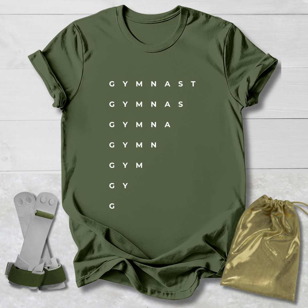 Green t-shirt with 'GYMNAST' text, socks, and drawstring bag on a light wooden surface