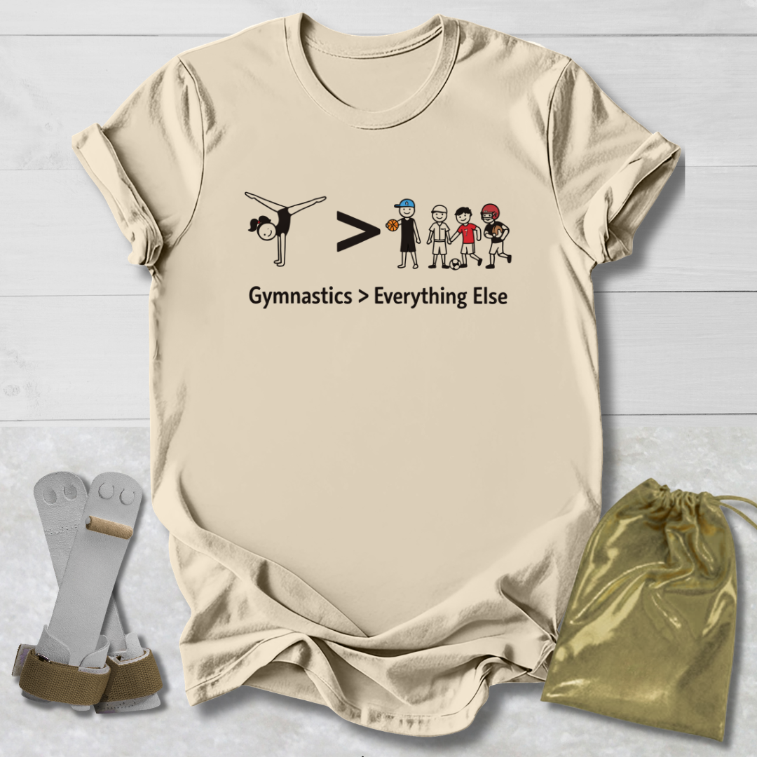 Beige t-shirt with gymnastics-themed graphic and text on a light wooden surface.