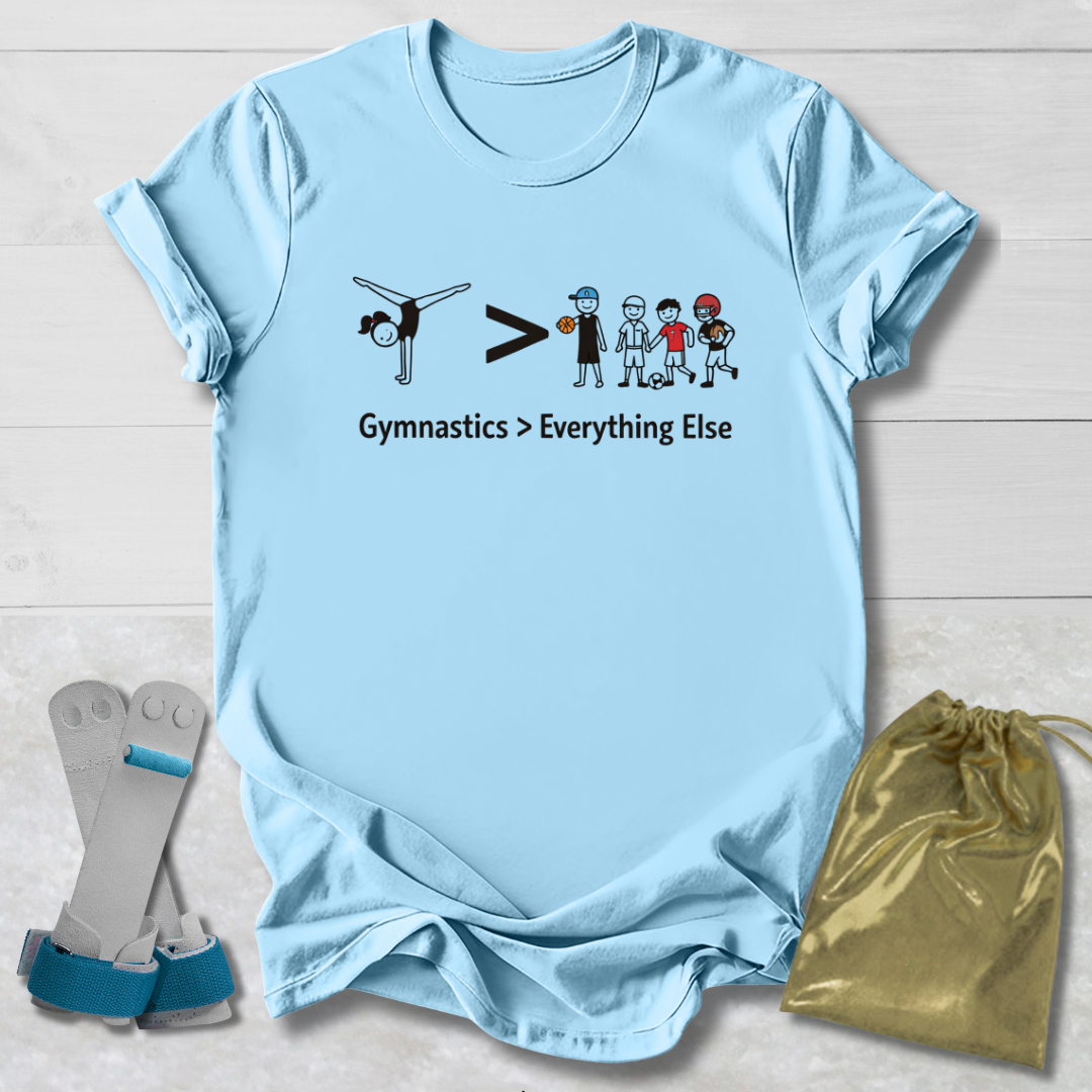 Light blue t-shirt with gymnastics graphic and text, socks, and drawstring bag on a wooden surface