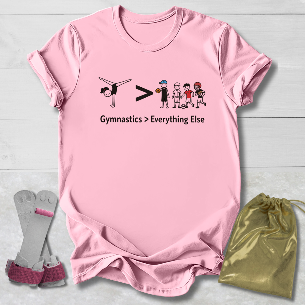 Pink t-shirt with gymnastics-themed design, socks, and drawstring bag on a light wooden surface