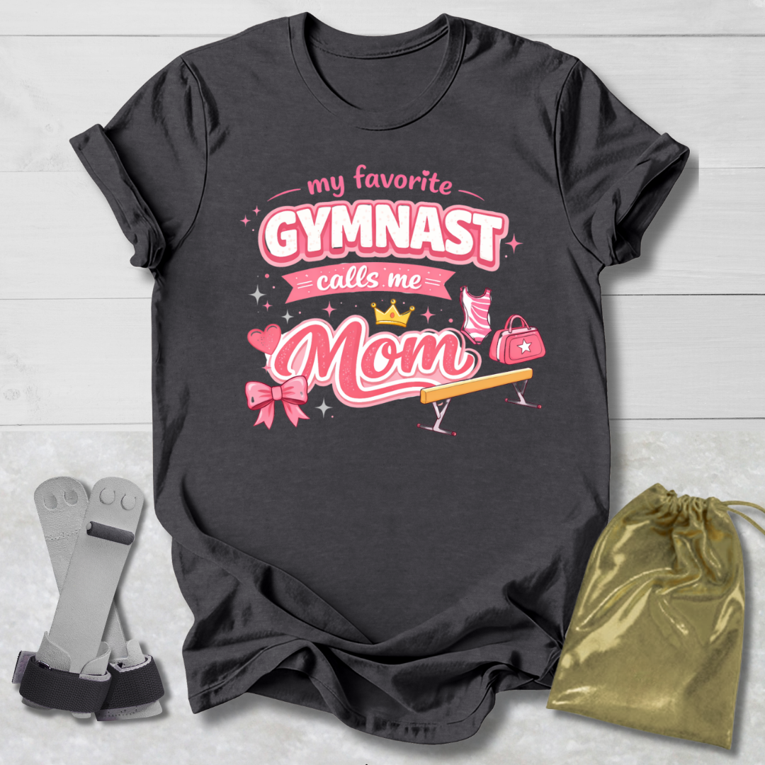 Black t-shirt with pink gymnastics-themed design, socks, and drawstring bag on a light wooden surface.