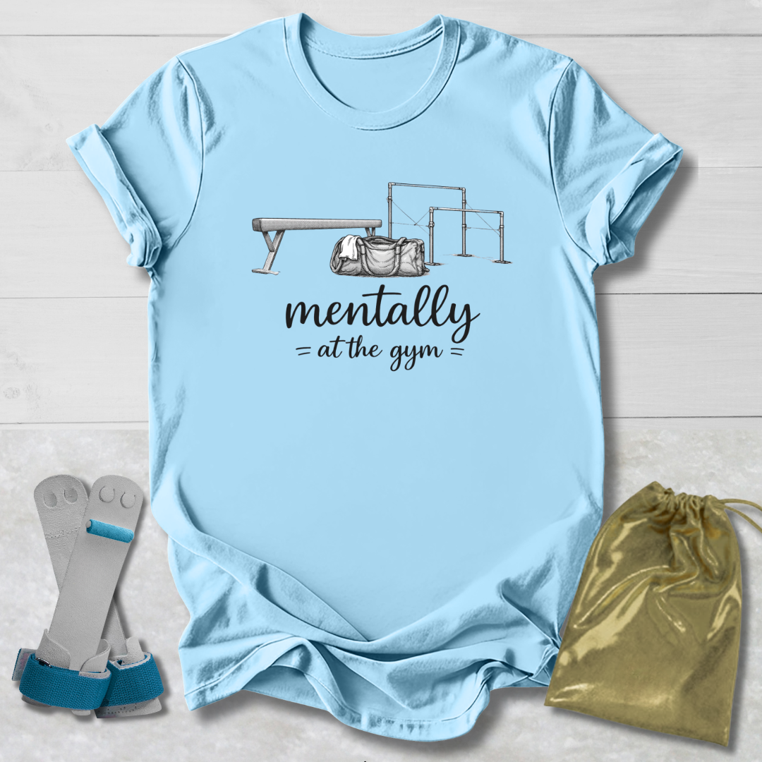 Light blue t-shirt with graphic and text, socks, and drawstring bag on a wooden surface