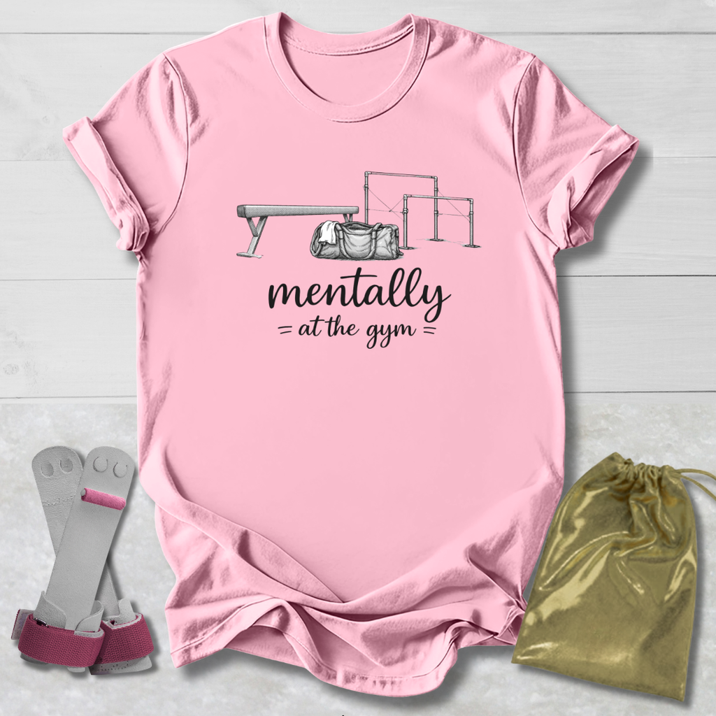 Pink t-shirt with graphic and text, socks, and drawstring bag on a light wooden surface