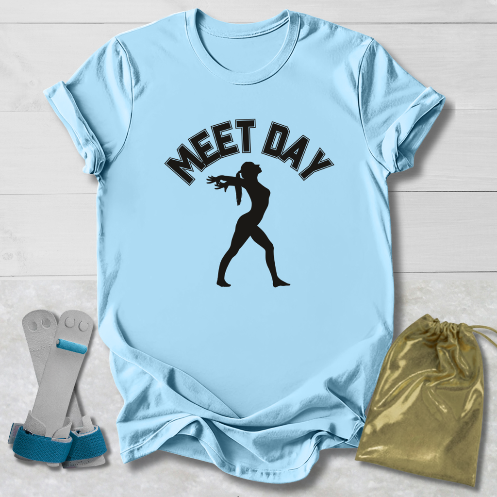Light blue t-shirt with 'MEET DAY' text and silhouette, socks, and drawstring bag on a wooden surface.