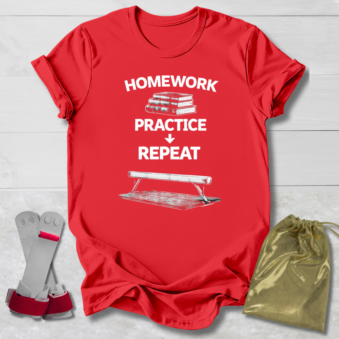 Red t-shirt with 'Homework Practice Repeat' text and graphic, socks, and drawstring bag on a light wooden surface.