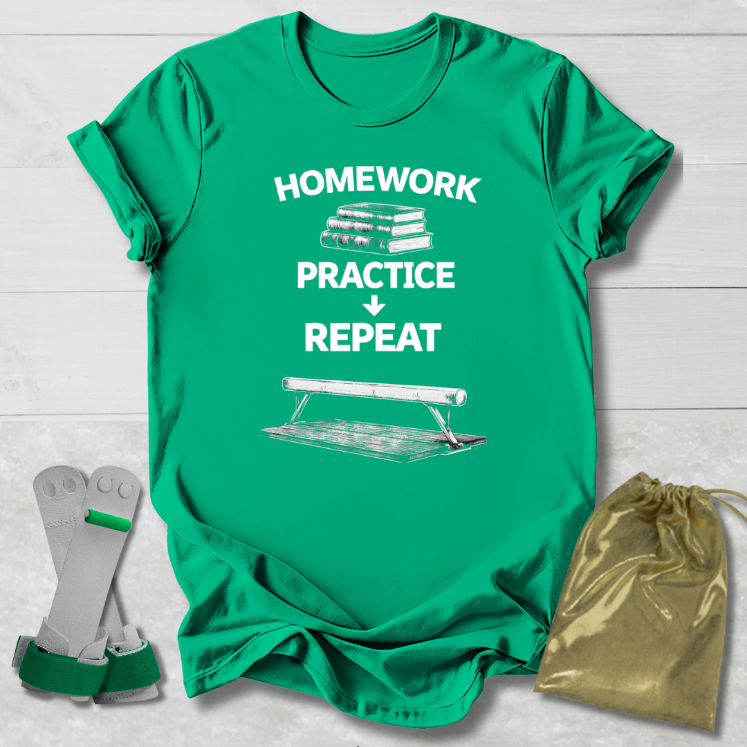 Green t-shirt with 'Homework Practice Repeat' text and graphics, socks, and drawstring bag on a light wooden surface.