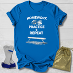 Blue t-shirt with 'Homework Practice Repeat' text and graphic, socks, and drawstring bag on a light wooden surface.