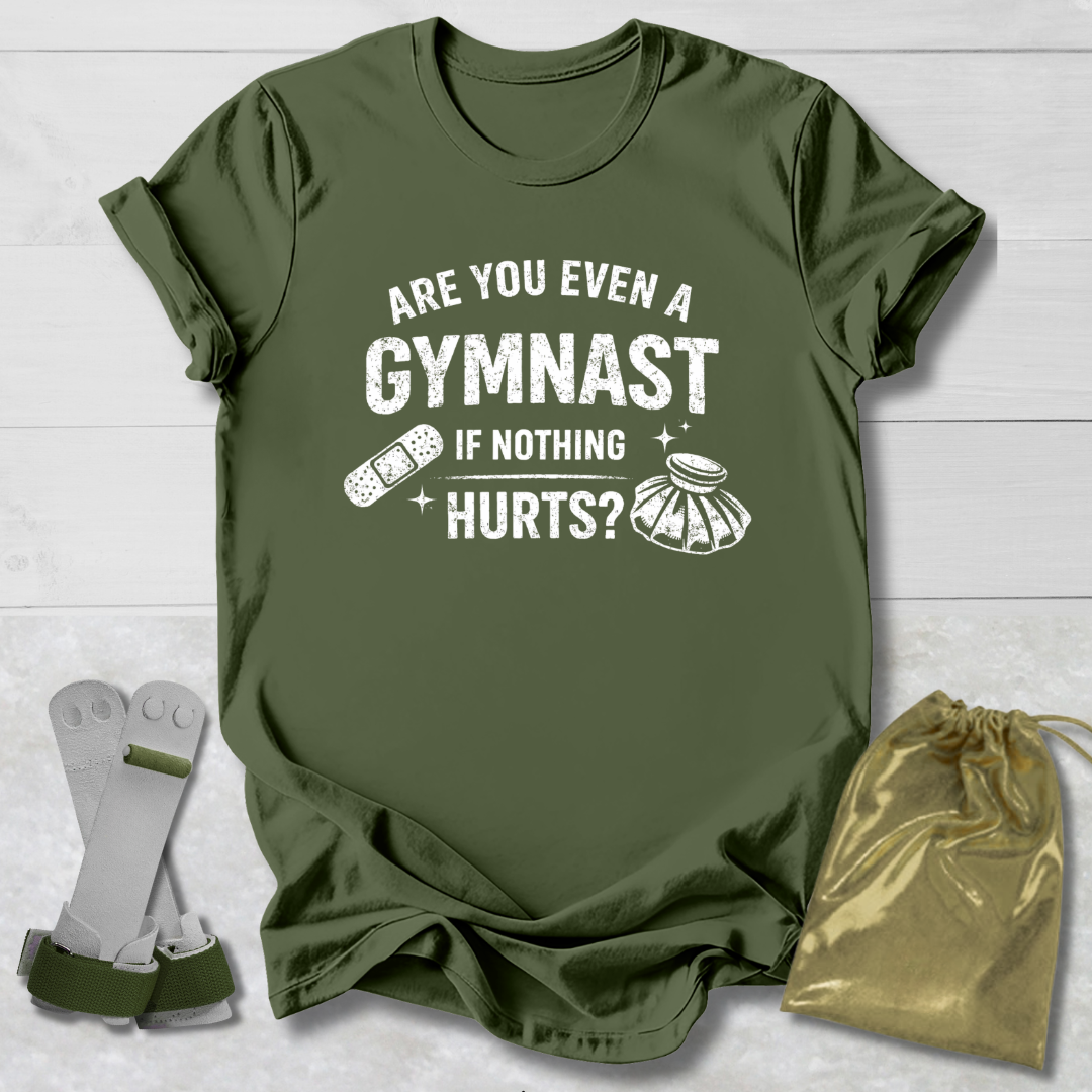 Green t-shirt with humorous gymnast graphic and text on a wooden surface.