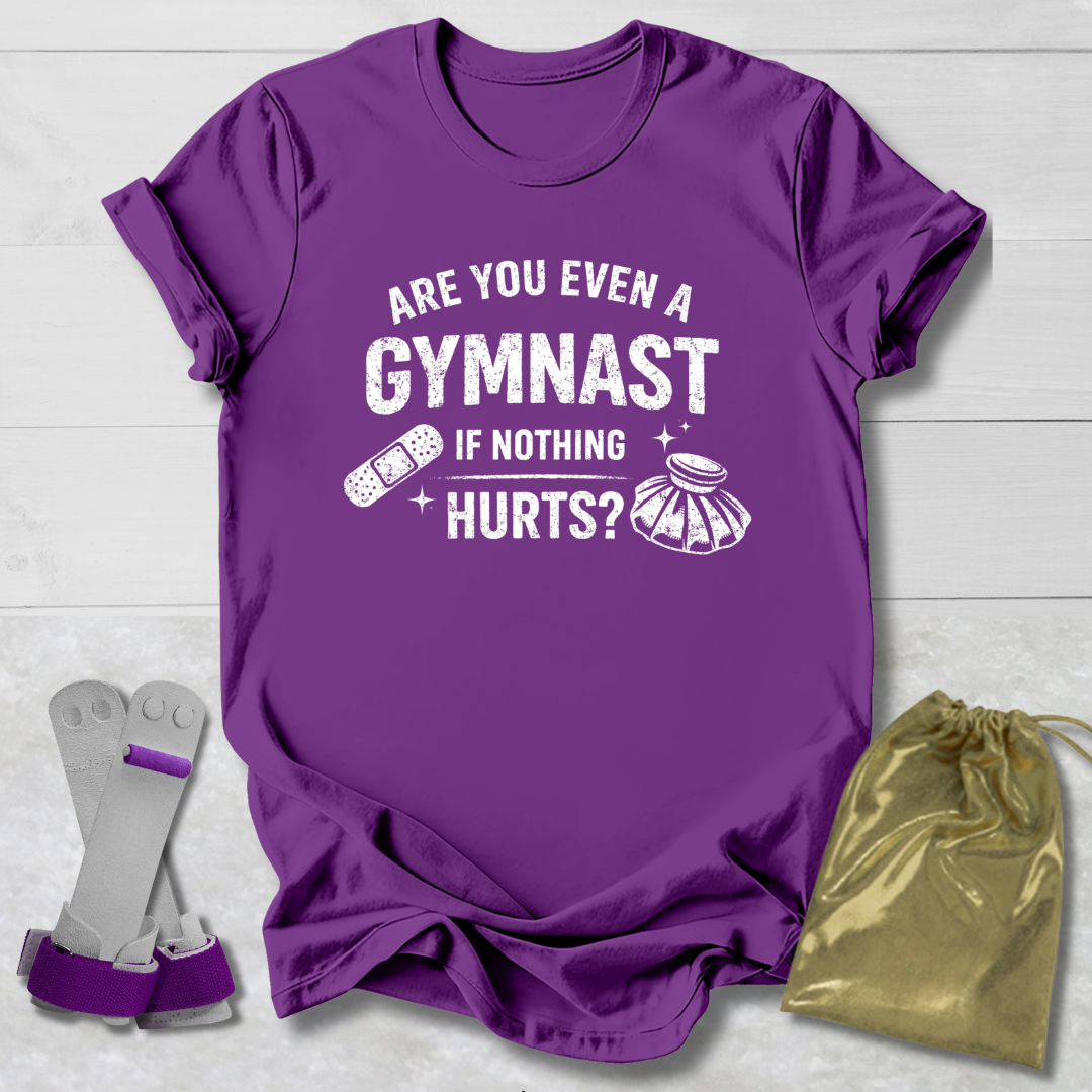 Purple t-shirt with humorous gymnast text, socks, and drawstring bag on a light wooden surface