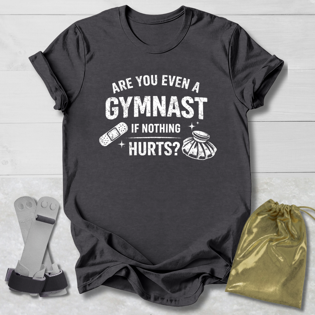 Gray t-shirt with humorous gymnast graphic and text on a light wooden surface.