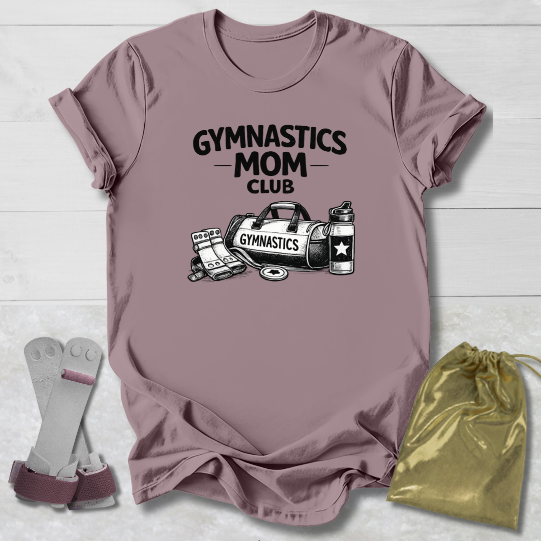 Mauve t-shirt with 'Gymnastics Mom Club' text and graphics, socks, and drawstring bag on a light wooden surface.
