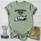 Green t-shirt with 'Gymnastics Mom Club' text and graphics, socks, and drawstring bag on a light wooden surface.