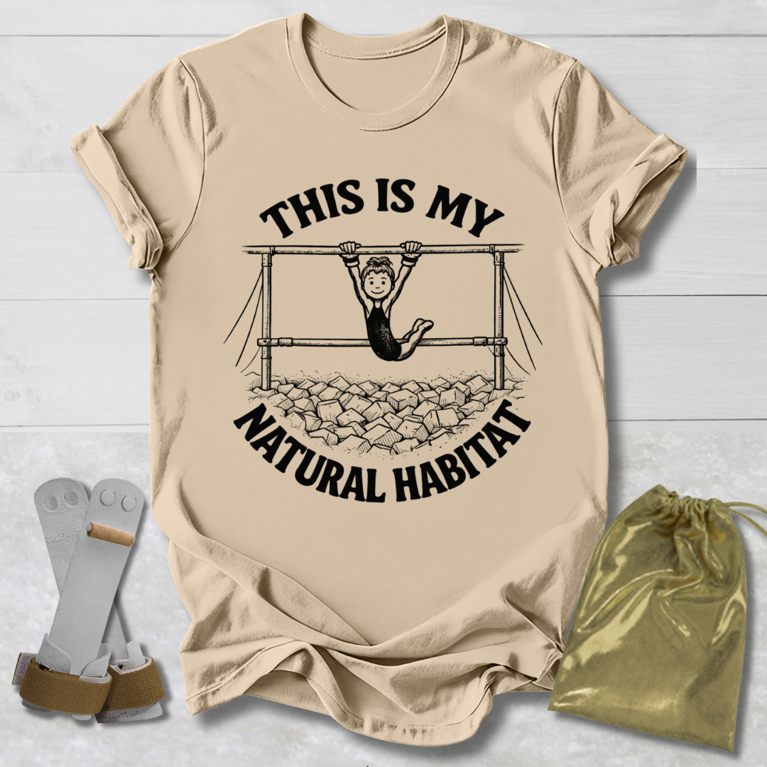 Beige t-shirt with graphic design and text on a light wooden surface.