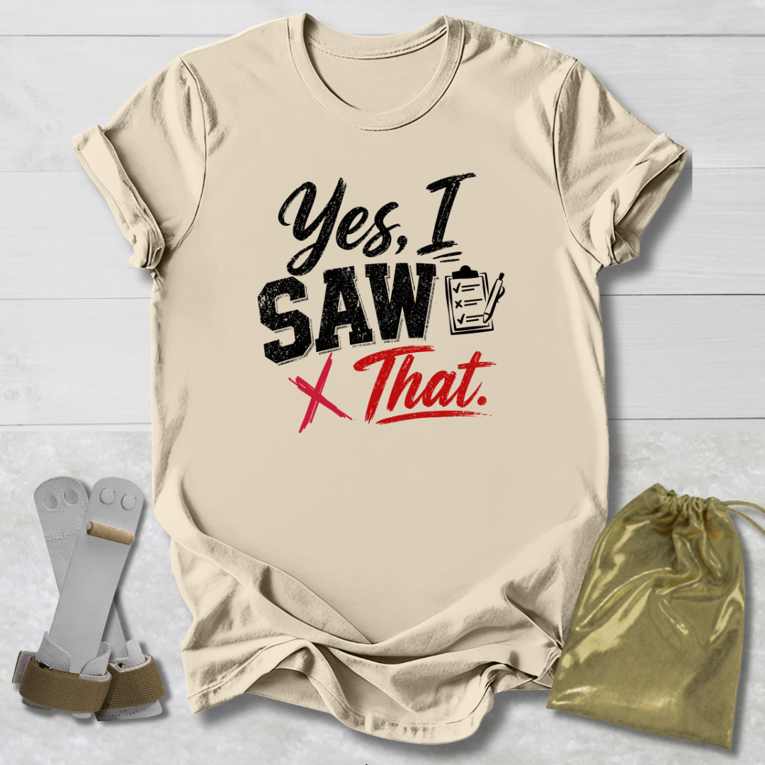 Beige t-shirt with humorous text design on a light wooden surface, accompanied by socks and a drawstring bag.