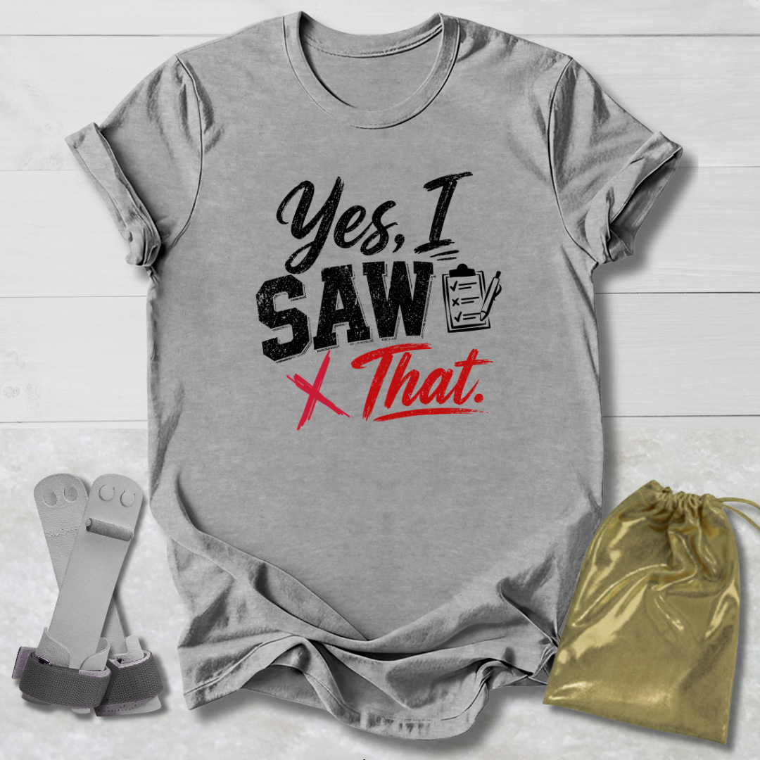 Gray t-shirt with 'Yes, I saw that' text on a wooden surface with socks and a drawstring bag.
