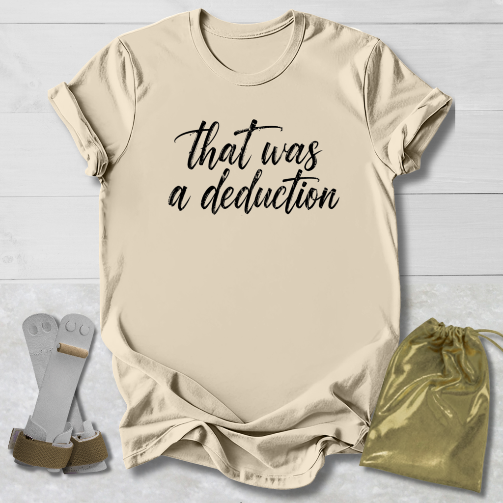 Beige t-shirt with 'That was a deduction' text, socks, and drawstring bag on a light wooden surface