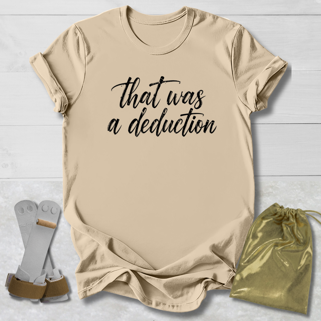 Beige t-shirt with 'That was a deduction' text, socks, and drawstring bag on a light wooden surface