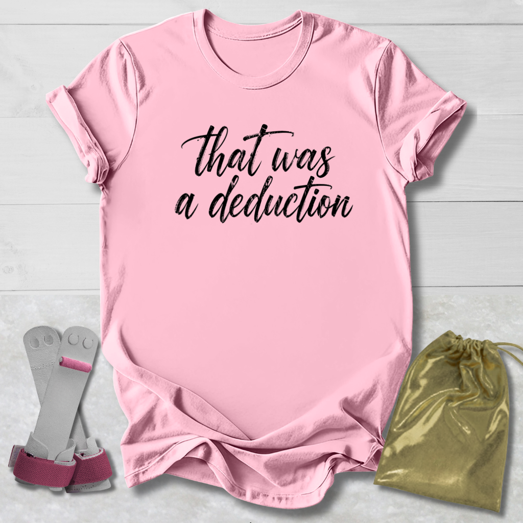 Pink t-shirt with text, socks, and drawstring bag on a light wooden surface
