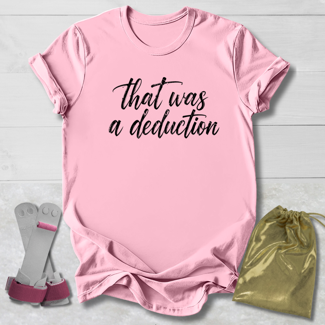 Pink t-shirt with text, socks, and drawstring bag on a light wooden surface