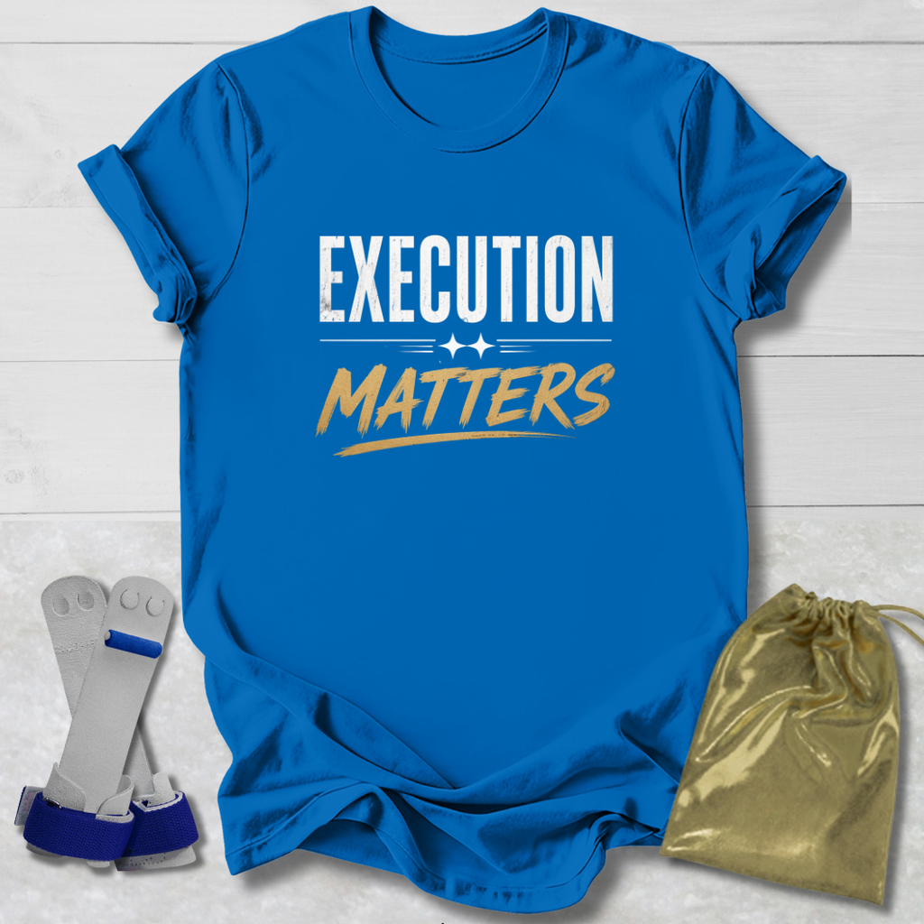 Blue t-shirt with 'Execution Matters' text on a wooden surface with socks and a drawstring bag.
