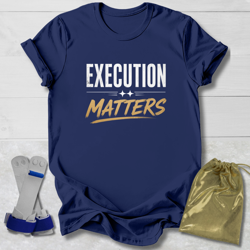 Navy blue t-shirt with 'Execution Matters' text on a light wooden surface with socks and a drawstring bag.