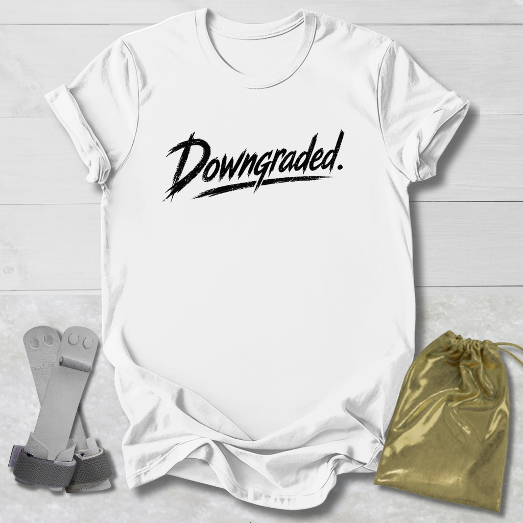 White t-shirt with 'Downgraded' text, socks, and a drawstring bag on a light wooden surface