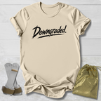 Beige t-shirt with 'Downgraded' text, socks, and drawstring bag on a light wooden surface