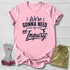 Pink t-shirt with text, socks, and drawstring bag on a light wooden surface